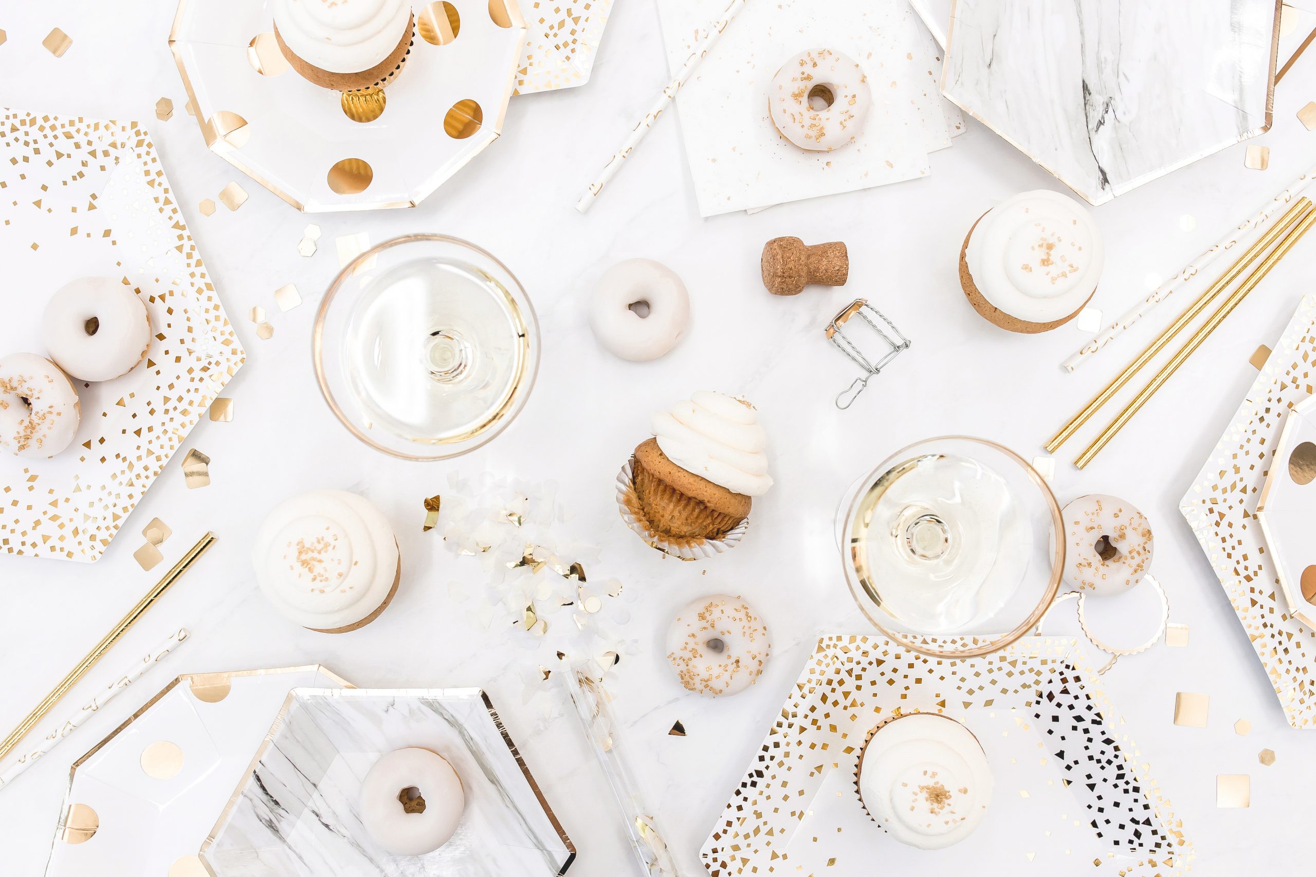 feestelijke tafel met witte donuts en gouden elementen